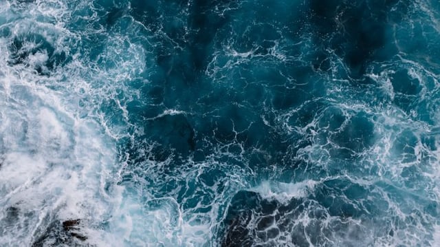 Aerial,View,To,Ocean,Waves.,Blue,Water,Background