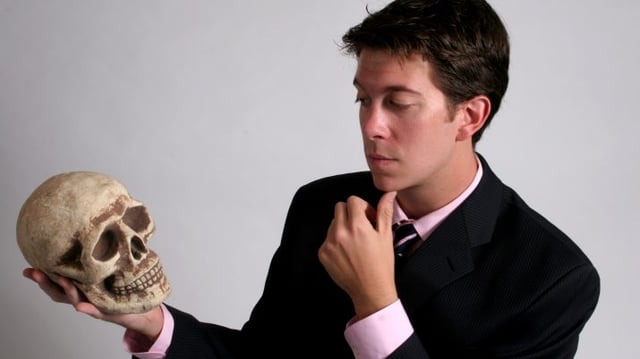 A,Young,Man,Pondering,On,A,Skull