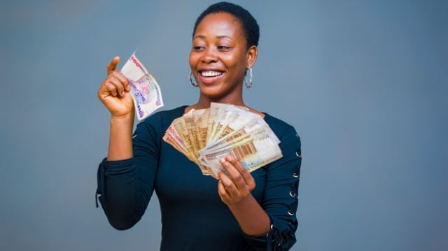A,Young,African,Girl,Playing,With,Her,Money