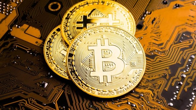 Golden,Coins,With,Bitcoin,Symbol,On,A,Mainboard.