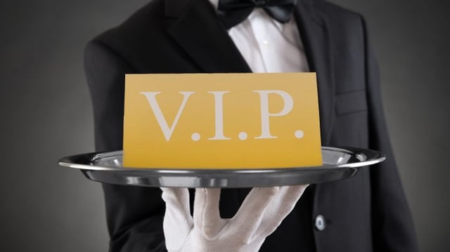 Close-up,Of,Waiter,Showing,Vip,Text,On,Banner