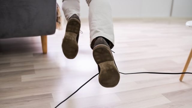 Close-up,Of,A,Man,Legs,Stumbling,With,An,Electrical,Cord