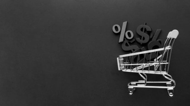 Carrinho de compras prata com símbolos representando dinheiro dentro. O fundo é preto. Representando a Black Friday da Vitreo