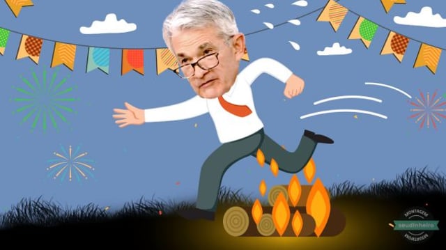 Montagem mostra o presidente do Fed, Jerome Powell, pulando uma fogueira em um cenário de festa junina