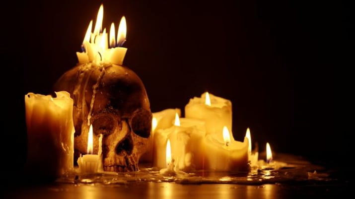 Candles,And,Human,Skull,In,Darkness,Close,Up