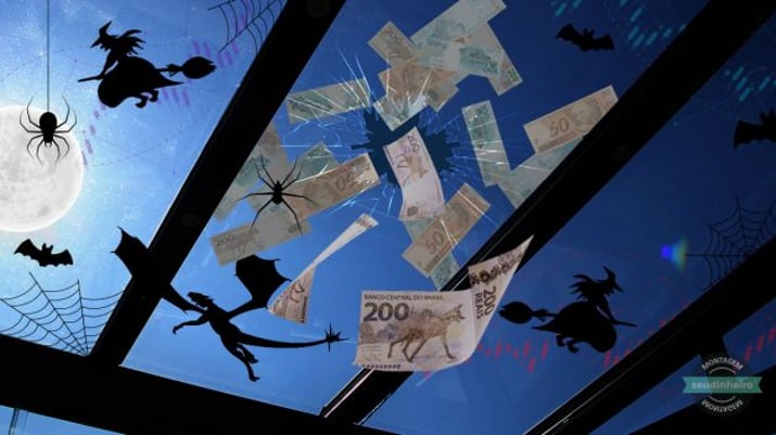 Teto de vidro rachado com dinheiro caindo por ele, sendo visto debaixo, com teias e aranhas, céu mostra lua, bruxas, morcegos e dragão sobrevoando, ao fundo gráficos de mercado financeiro