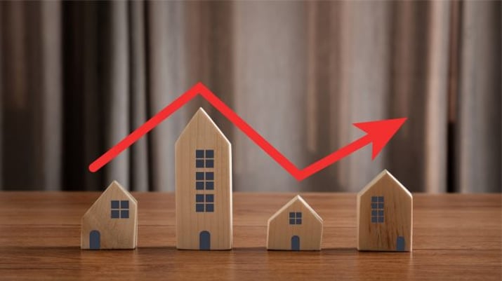 Imagem mostrando casas de brinquedo enfileiradas, com uma seta vermelha que sobe e desce sobre os telhados. É um símbolo do desempenho dos fundos imobiliários (FIIs) | Dividendos RECR11 fundo imobiliário Maxi Renda MXRF11 KINP11 CPTS11 HCTR11