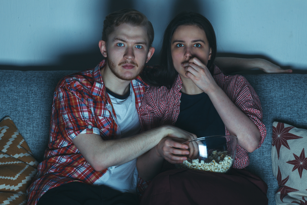 Casal come pipoca e assiste a filme