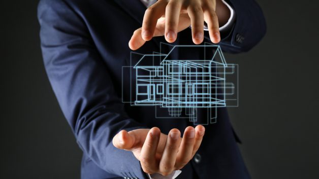Real,Estate,Offer.,Businessman,Holds,An,Artificial,Model,Of,The