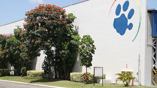 Fachada branca com o símbolo da empresa Tigre, uma pata felina azul
